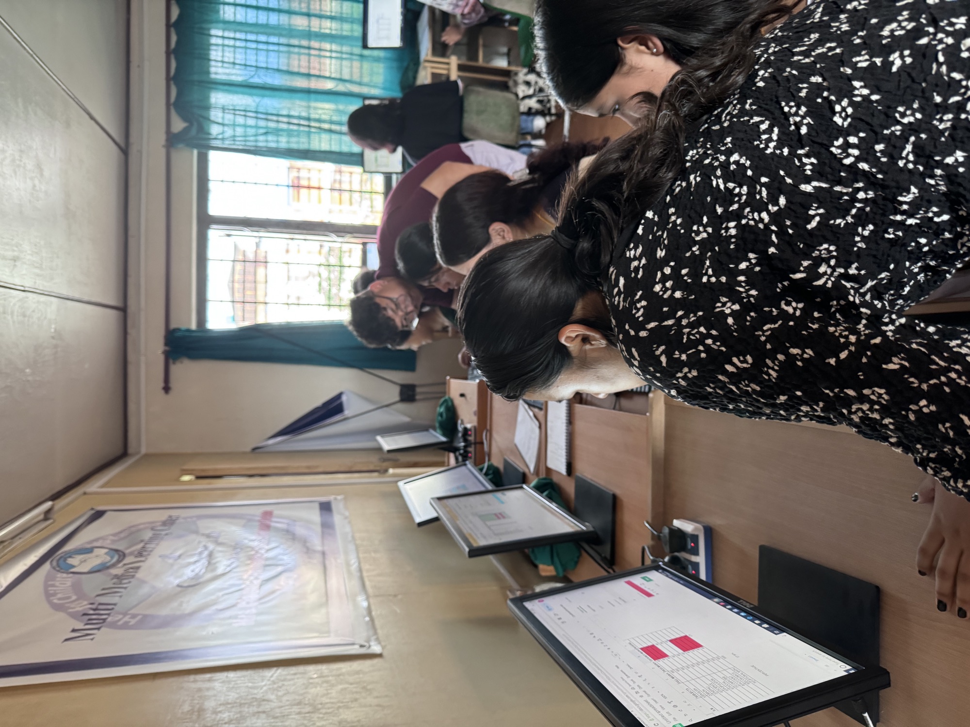 She Learns Tech participants working on laptops at their desks