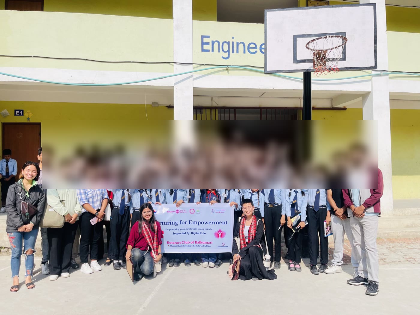 Digital Kala team with students at Shramik Shanti Secondary School, holding the Nurturing for Empowerment banner