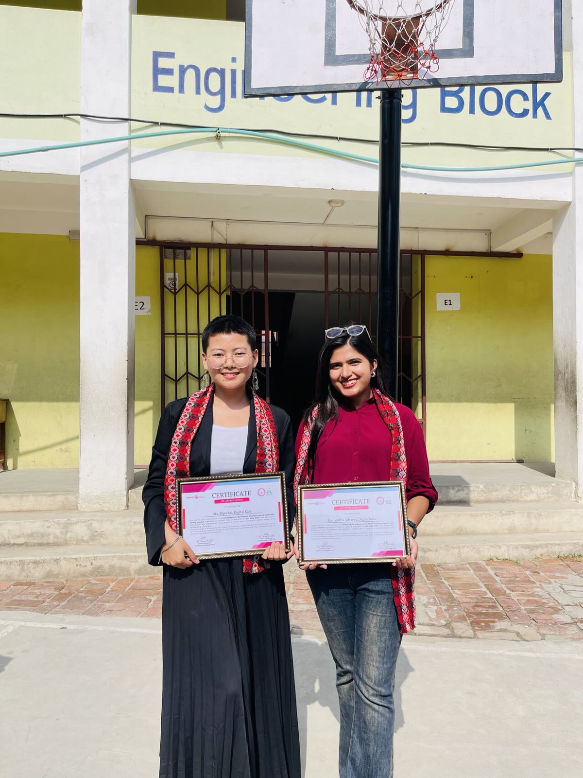 Aastha and Dipa with certificates of appreciation