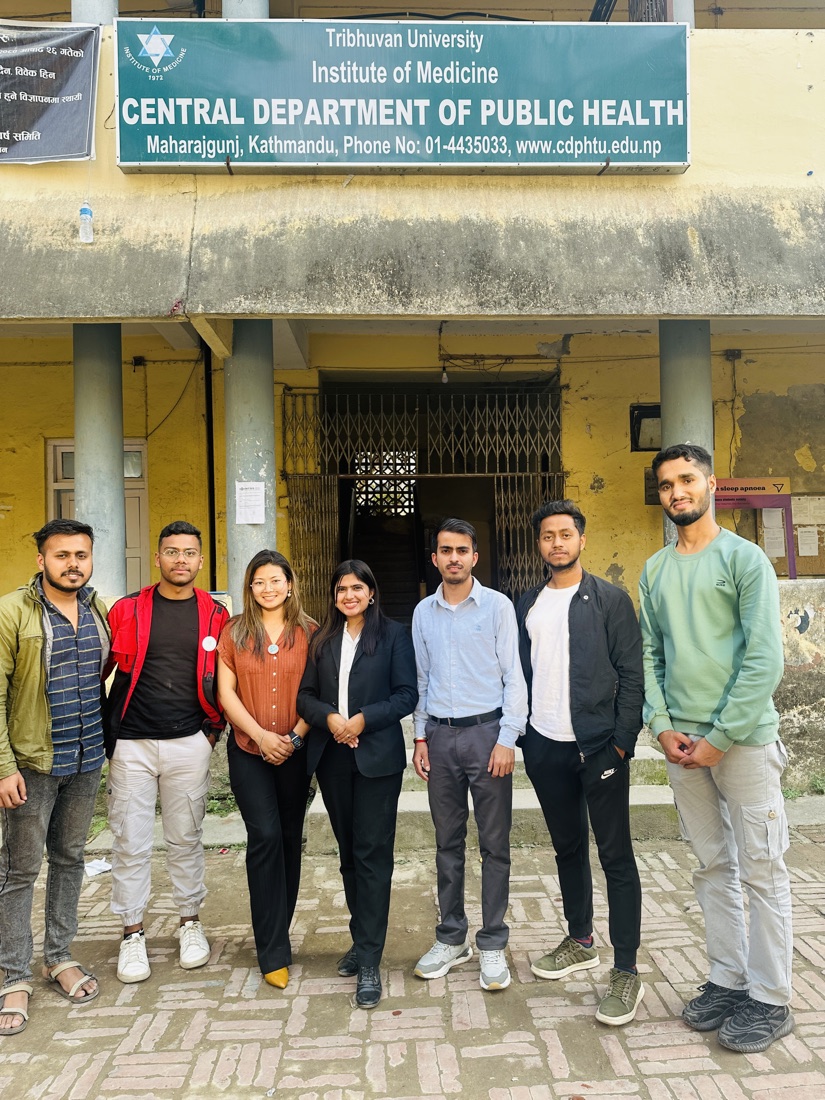 The Digital Kala team outside the Central Department of Public Health sign at Tribhuvan University