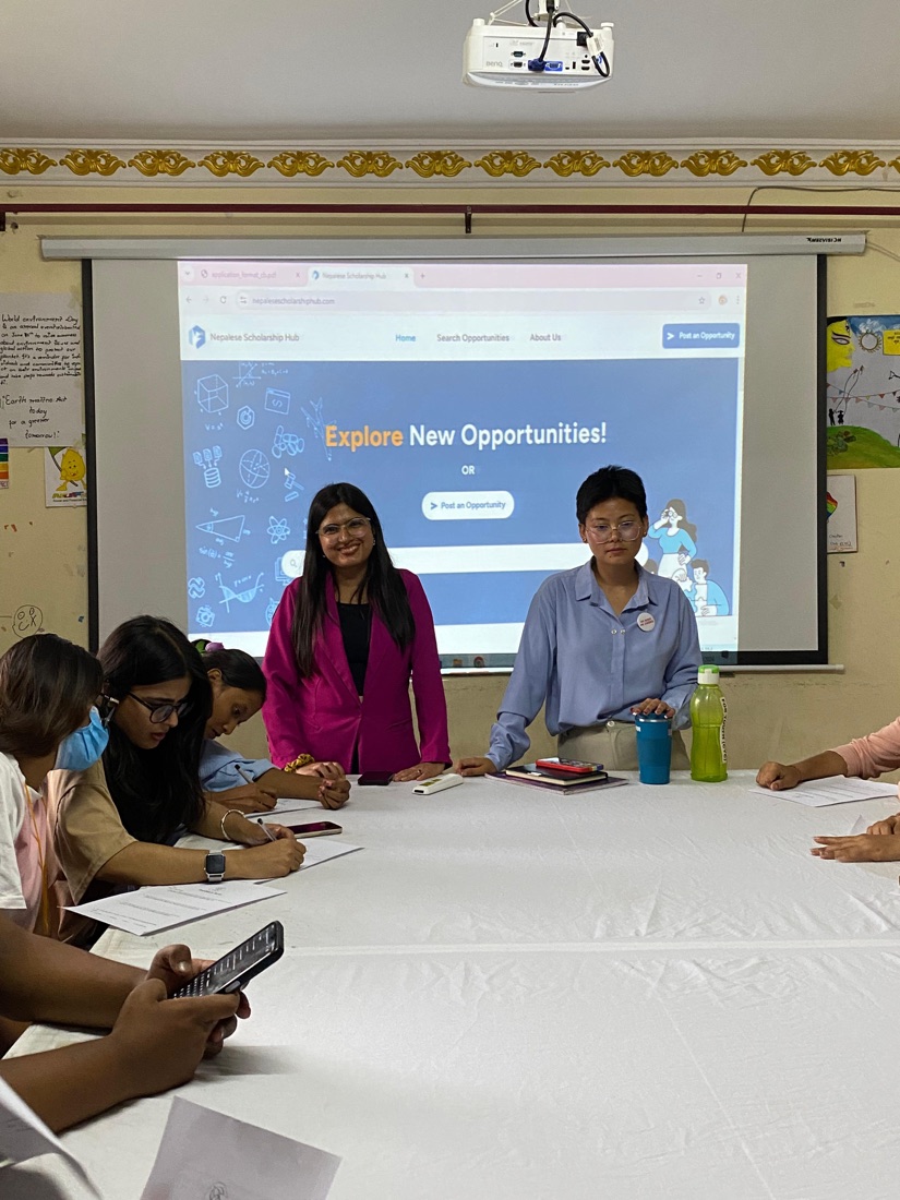 Dipa Rai and a co-facilitator leading the session in front of a projected slide while participants take notes