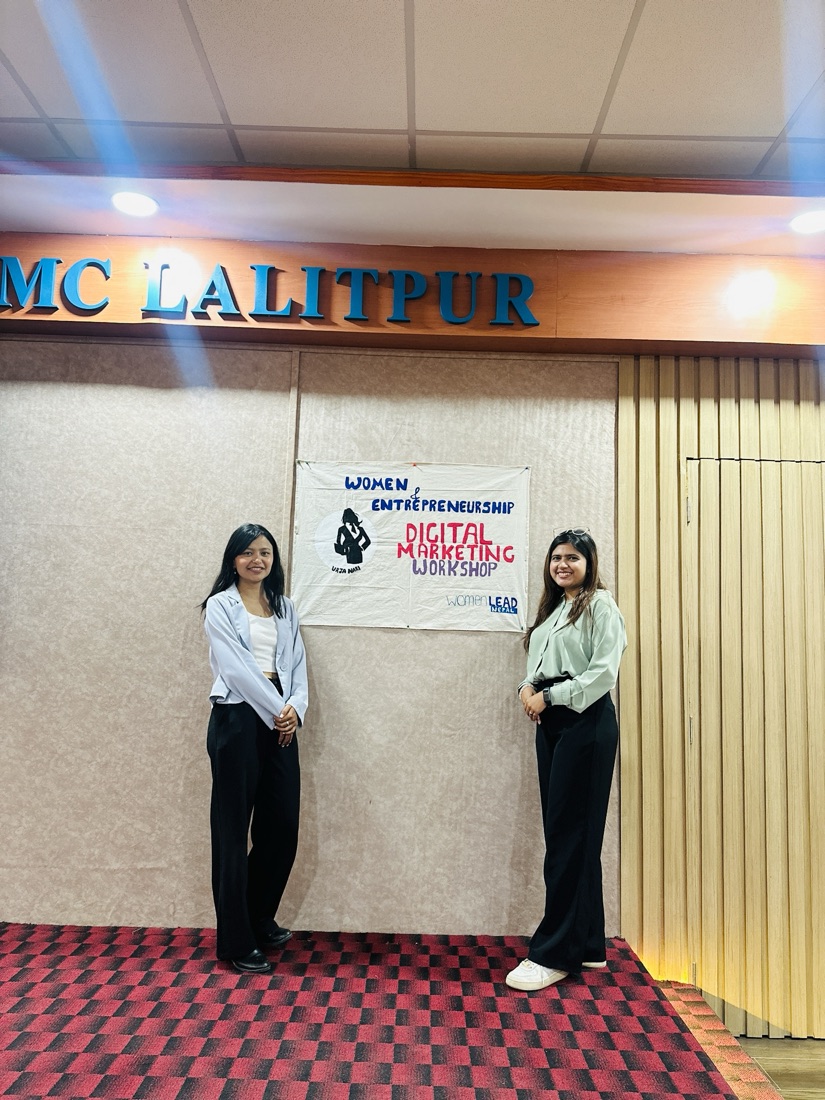 Pooja Shrestha and Aastha Acharya beside the Digital Marketing Workshop banner at KMC Lalitpur